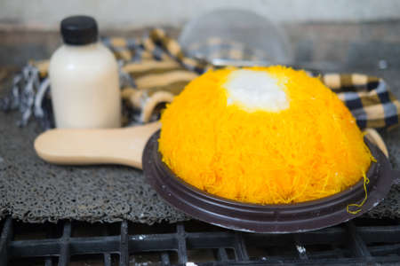 Thai homemade bakery. Sweet Gold egg yolk thread cakes with coconut cream ,selective focusの写真素材