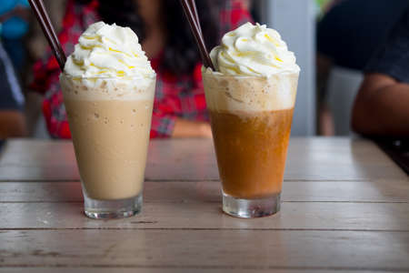 Two iced drink with wipped cream on top  (coffee and chocolate)