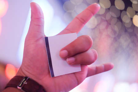 Hand signs showing thumb love with a paper ticketの写真素材