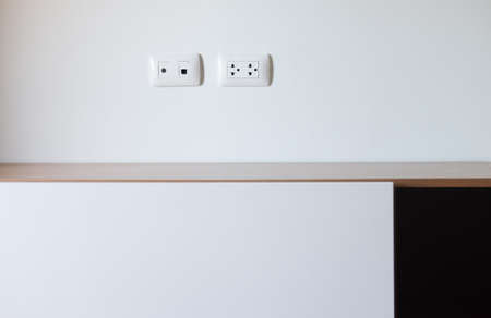 Empty wood shelf with electric outlet in homeの写真素材