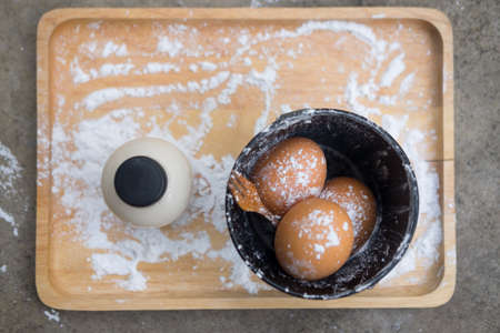 Flour and eggs on wooden background. Ingredients for dough preparationの写真素材