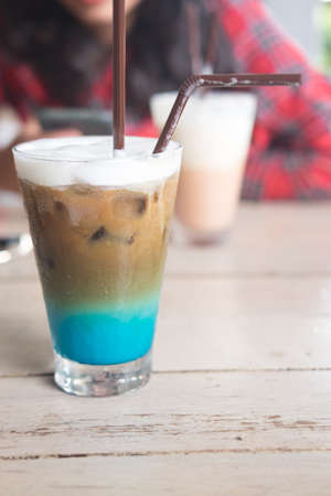 A multicolored, three layered opaque coffee in a glass with ice, with the taste of menthol, coffee, caramel, cream.の写真素材