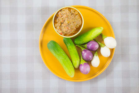 Thai chilli tamarind sauce dip served with cucumber and eggplantの写真素材
