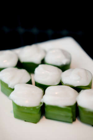 Thai pudding filling taro and topping coconut cream in banana leafの写真素材