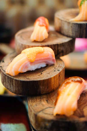 Sushi nigiri with salmon served on sheet woodの写真素材