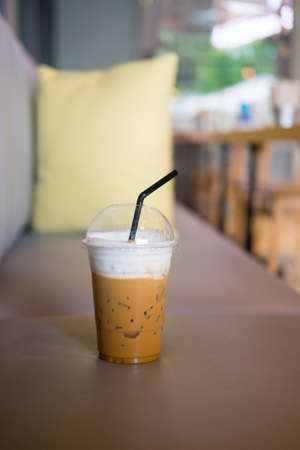 A cup of iced cappuccino coffee put on sofa (selective focus)の写真素材