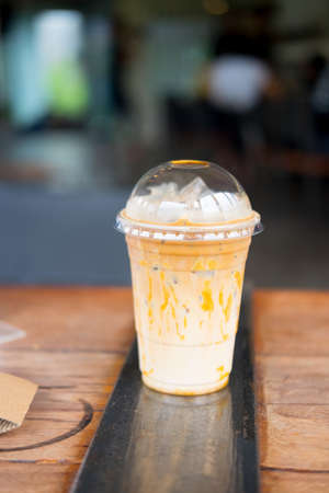 Iced caramel macciato coffee with milk. Cold sweet refreshing summer drink conceptの写真素材