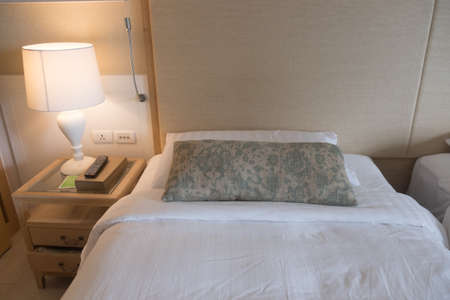 Bedding near lamp area in hotel roomの写真素材
