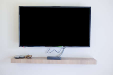 Black LED tv television screen blank on wall in living roomの写真素材
