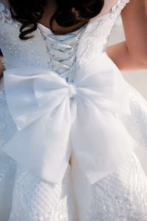 Close-up image of the detailed laces on the back of a wedding dressの写真素材