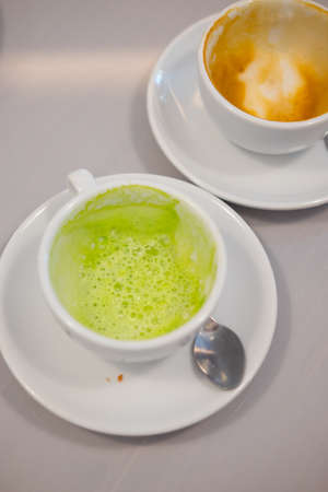 Close up dirty coffee and green tea cup. Dirty cup