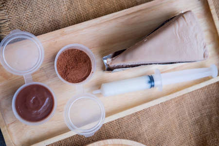 Piece of chocolate cake served with topping you can decor cakeの写真素材