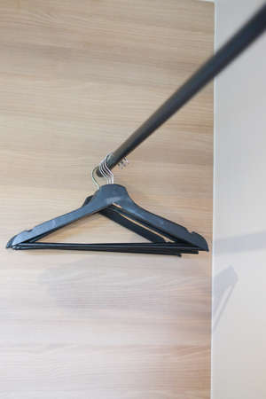 Empty clothes on black plastic hanger in closetの写真素材
