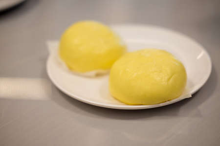 Close up yellow steamed bun on a plate