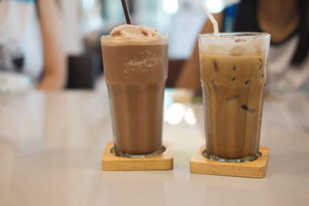 Glass of chocolate milkshake and iced coffee in coffee shopの写真素材