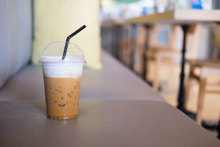A cup of iced cappuccino coffee put on sofa