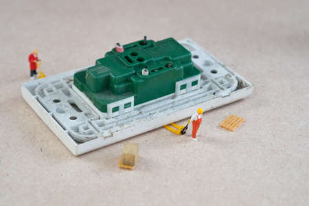 Miniature people: Worker team of move for repairing electrical outlets. repair concept.の写真素材