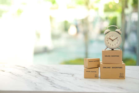 Miniature package box and mini watch with service mind. Fast and easy online shopping conceptの写真素材
