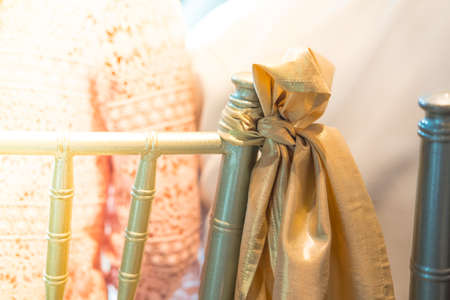 Beautiful chairs decoration with ribbon in wedding event hall selective focus.の写真素材