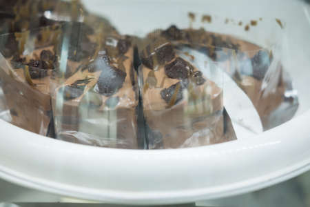 Close up of chocolate cake in showcase at a bakery shopの写真素材