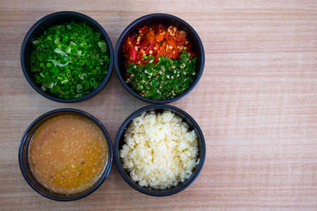 Sauces and condiments for Shabu and Sukiyaki put on wooden tableの写真素材