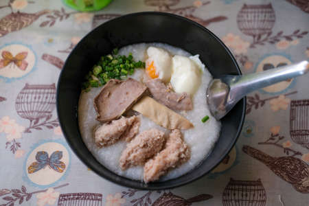 Rice porridge rice gruel congee rice soup with egg, liver and pork. Breakfast food concept.の写真素材