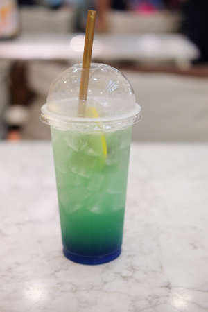 Colorful refreshment drinks lemonade in plastic glassesの写真素材