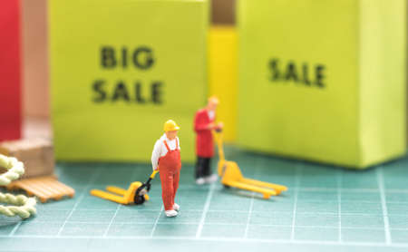 Sale concept. Miniature worker prepare for transport order from online shoppingの写真素材