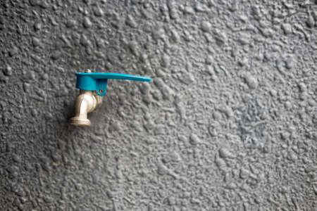 Water tap on wall in ourdoor. Front view with copy space.の写真素材