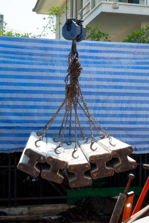Move concrete foundation piles in construction site. House construction concept
