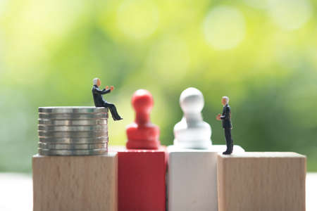 Miniature businessman face to face for negotiating in business. Strategy concept and business competition conceptの写真素材