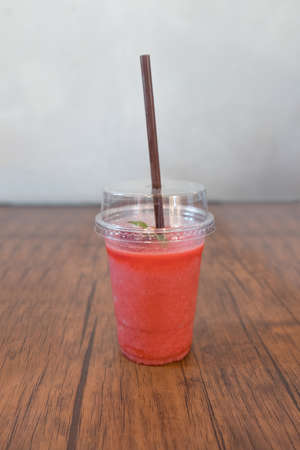 Strawberry smoothies put on brown wooden table