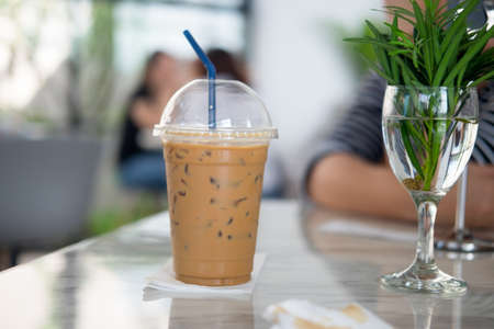 Iced mocha with blue straw in plastic cupの写真素材