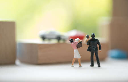 Miniature people adult couple and baby figure standing and looking to further. Concept of retirement...
