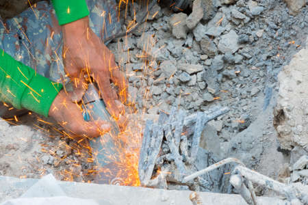 Man use electric steel cutter and clamp metal  in construction site. Construction conceptの写真素材
