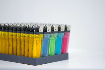 Multicolored gas lighter in package. Plastic gas lighter close upの写真素材