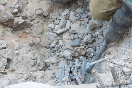 Worker use demolish tool for concrete surface and then make finishing concrete surface in construction job siteの写真素材