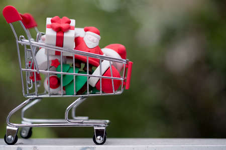 Christmas decorative items in mini shopping cart. Christmas and New year sale creative idea.