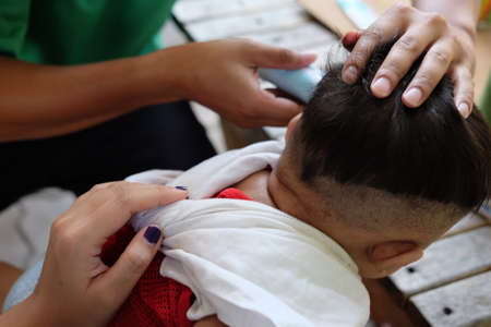 Father cuts machine child at home. For any purpose. concept of family