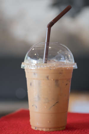 Cup of iced mocha coffee on red table background. food and drink conceptの写真素材