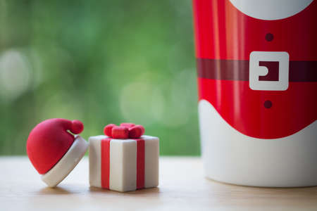 Miniature santa hat and christmas gift box. Christmas presents from santa