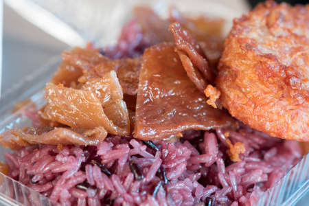Fried pork and black sticky rice is a fast food for people who want to have breakfastの写真素材