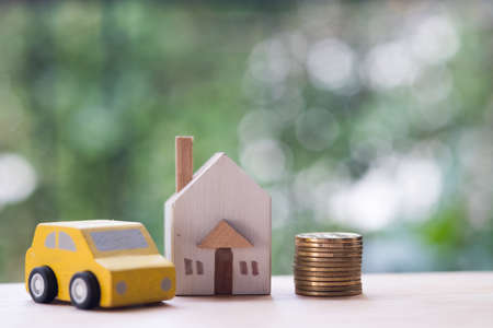 Miniature house, car and money in the concept of money to buy a home and a car, divided the investment for retirementの写真素材