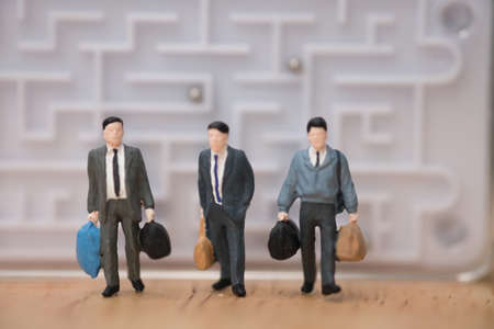 Miniature people: Businessman standing front maze move forward to the future concept, problem solving and challenge.の写真素材