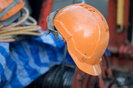 Orange helmet at construction site, concept of lunch time at the production plant or a construction...