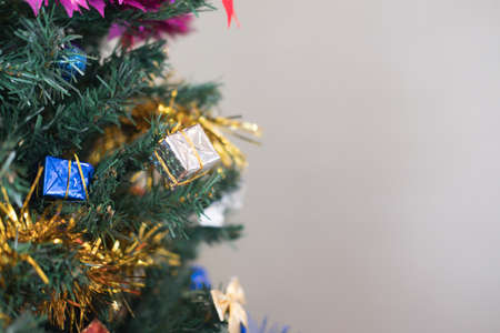 Gift box hanging on pine tree branch. Christmas decorationの写真素材