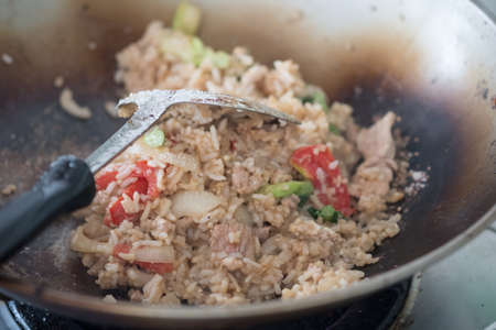 Asian fried rice with pork and vegetable in a frying panの写真素材