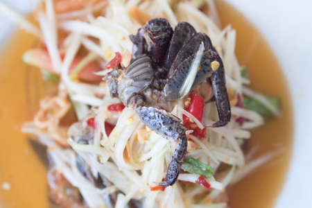 Thai food spicy green papaya salad crab in plate at restaurantの写真素材