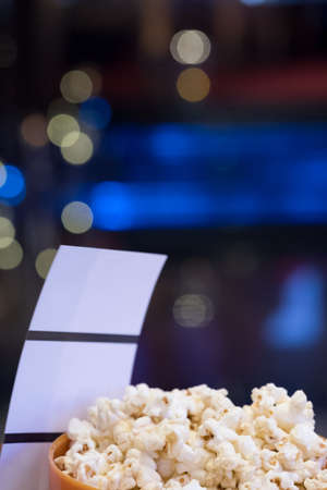 Paper tickets and popcorn for going to the movies