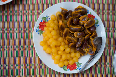 Golden Jackfruit Seeds, Mung Bean Marzipan and Egg Yolk Dessert served with Tong Yod (Sweet Egg Yolks Drops) made from egg yolk and flour mixture and cooked in syrupの写真素材